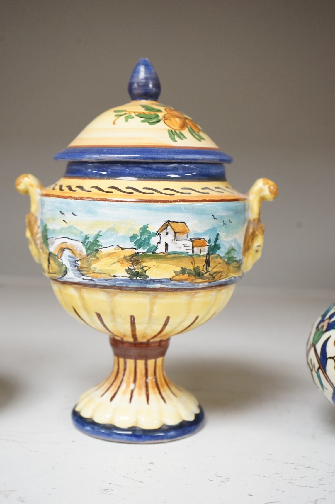 A pair of Isnik pottery vases and majolica vase and cover, largest 22cm high. Condition - fair, some restoration